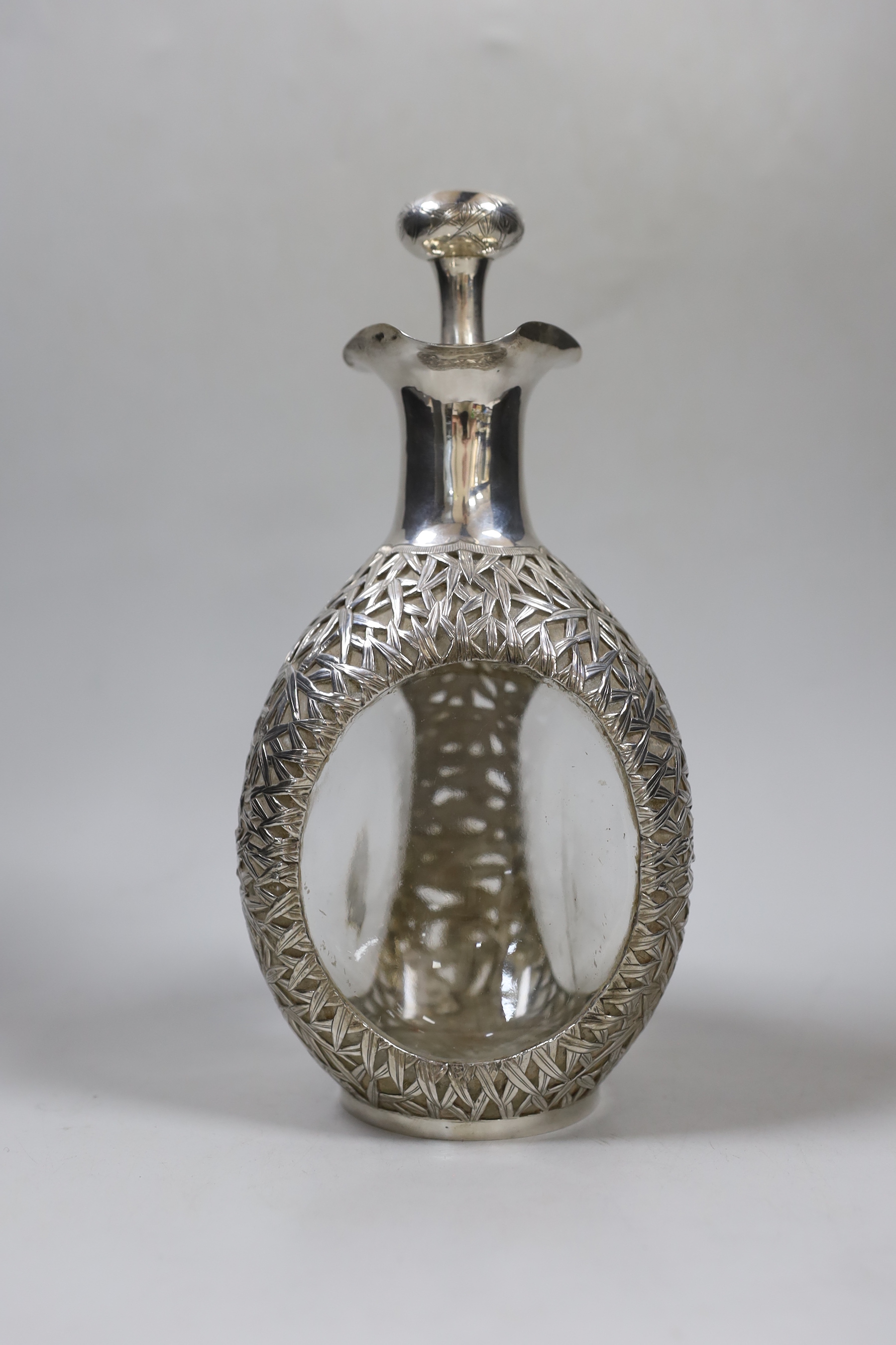 An early 20th century Chinese white metal mounted glass Haig decanter and stopper, Hong Kong, height 26.3cm.